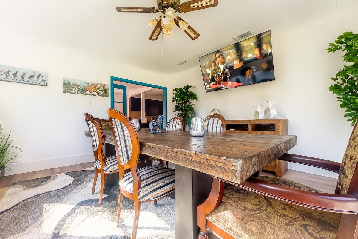 Wood dining table and gathering space at the three-bedroom Breezy Lawn retreat in Ellenville
