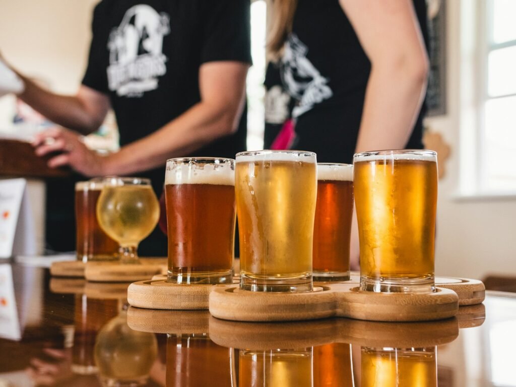 Craft beer and cider tasting flight on a wooden sampler board