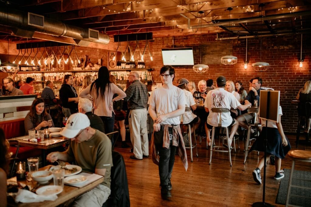 Illustrative people dining together at restaurant tables; not a specific Hudson Valley venue
