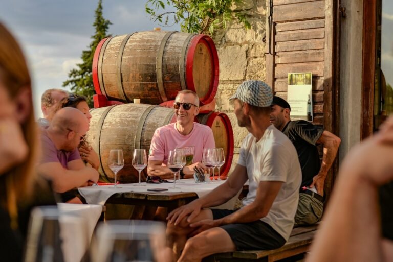 Illustrative guests enjoying a wine tasting among barrels; not a photograph of the named Hudson Valley destination
