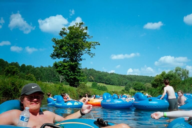 Illustrative people floating on a river in summer tubes; not a specific Hudson Valley attraction