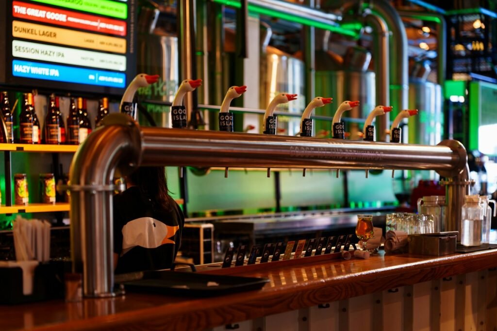 Illustrative beer taps and bottles behind a bar; not a specific Hudson Valley venue