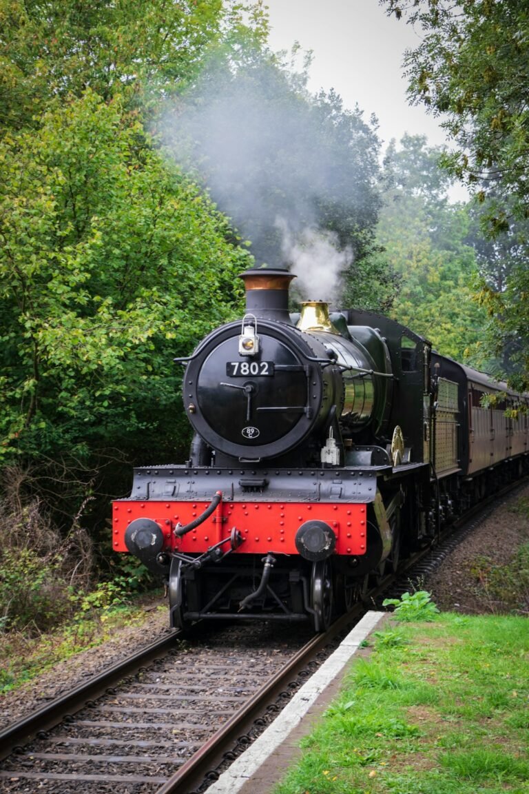 Illustrative historic train on tracks beside trees; not a specific Hudson Valley attraction