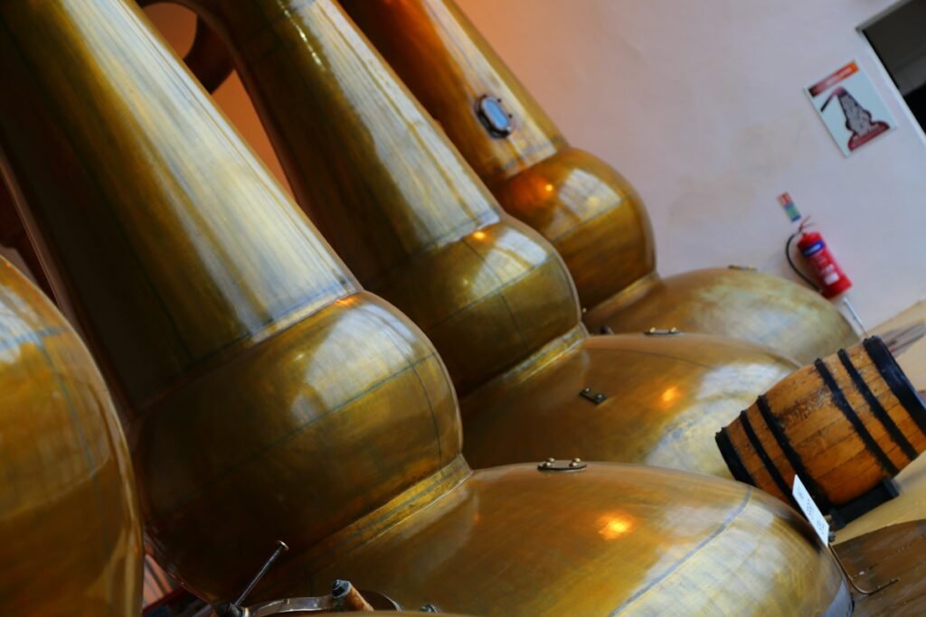 Illustrative golden copper stills inside a distillery; not a specific Hudson Valley venue
