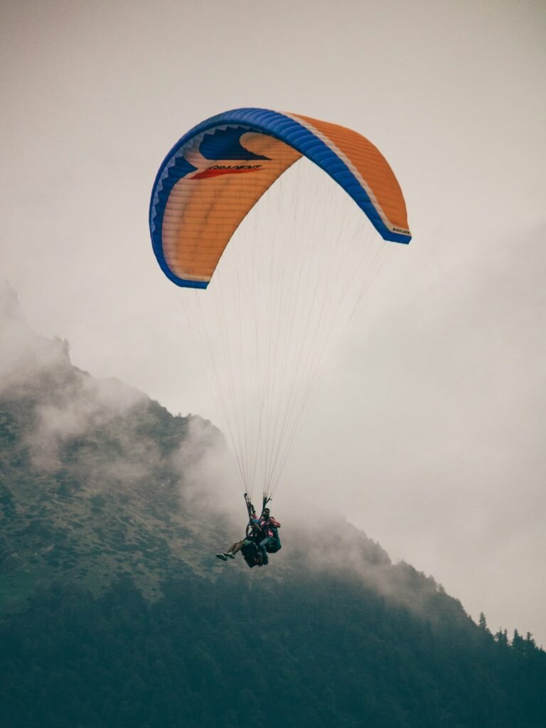 Illustrative paraglider soaring above mountain scenery; not a verified photograph of the named Hudson Valley destination