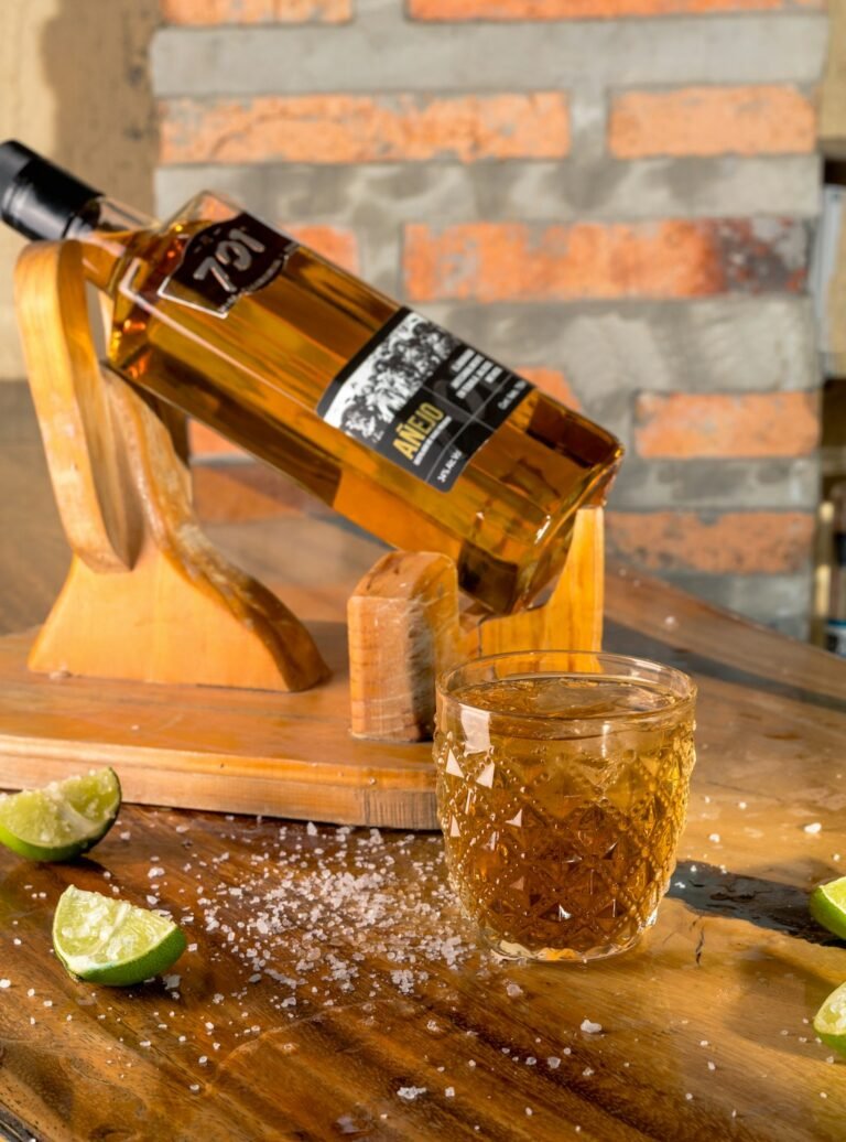 Illustrative tequila bottle and glass with lime wedges, not the private masterclass